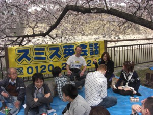Talking with students under the blossoms in Osaka Castle Park
